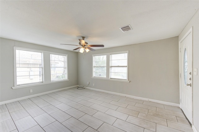 unfurnished room with ceiling fan