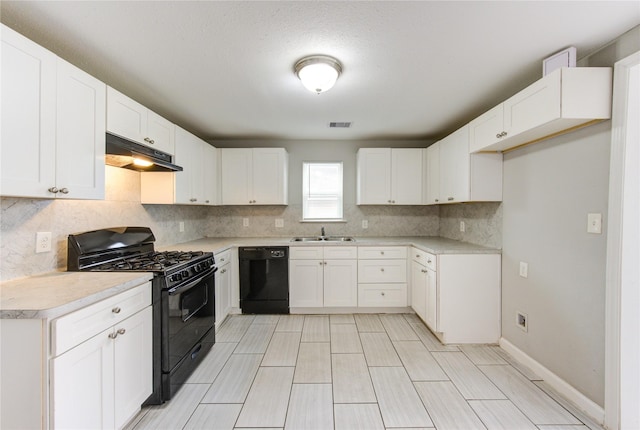 kitchen featuring white cabinetry, sink, backsplash, and black appliances