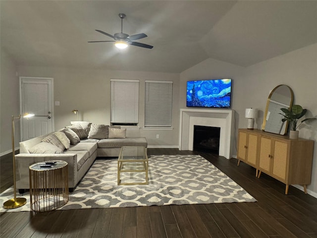 living room with ceiling fan, lofted ceiling, and dark hardwood / wood-style flooring