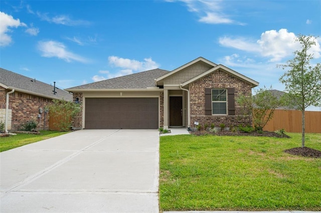 view of front of property featuring a garage and a front lawn