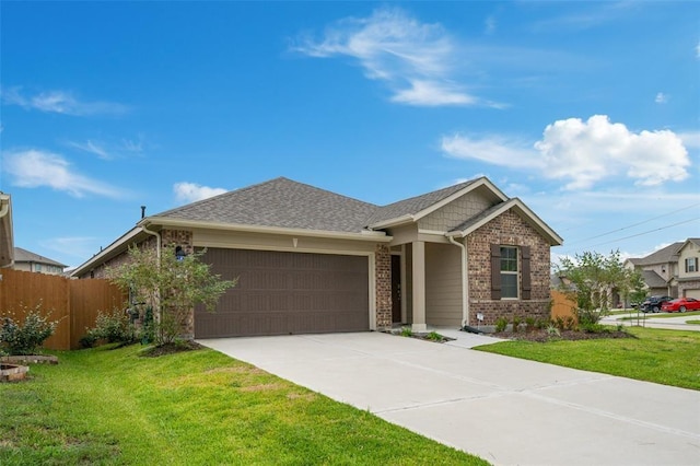 view of front of property featuring a garage and a front lawn