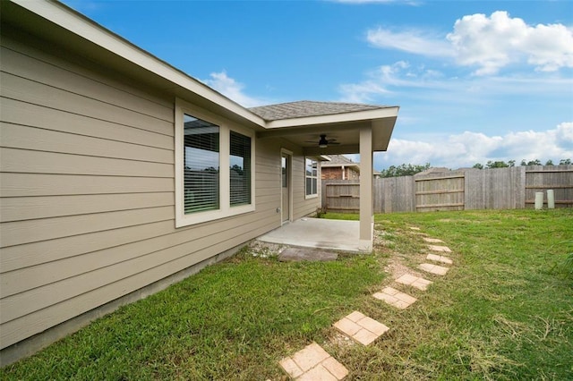 view of yard featuring a patio and ceiling fan