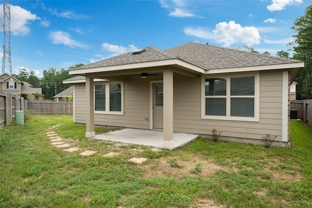 back of house with a patio area, ceiling fan, and a lawn