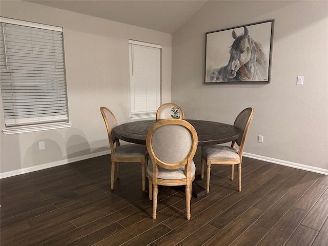 dining area with lofted ceiling and dark wood-type flooring