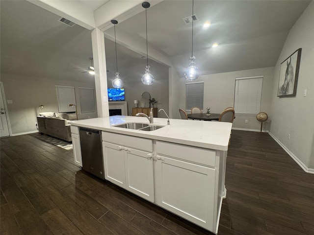 kitchen featuring pendant lighting, white cabinetry, sink, vaulted ceiling with beams, and stainless steel dishwasher