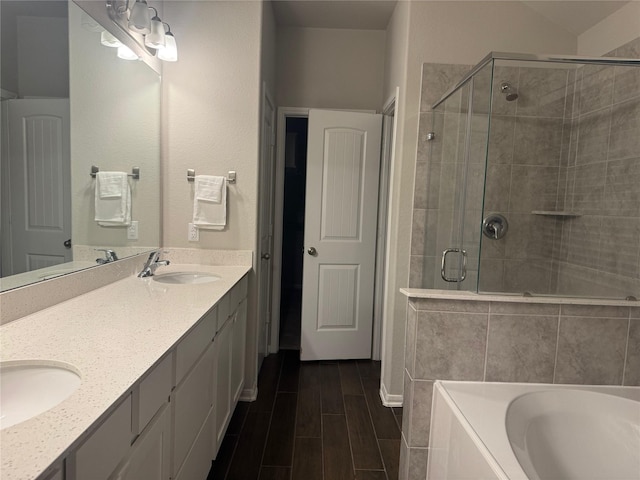 bathroom featuring shower with separate bathtub and vanity