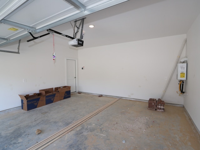 garage with tankless water heater and a garage door opener