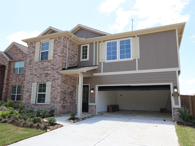 traditional-style home featuring an attached garage, board and batten siding, driveway, and brick siding