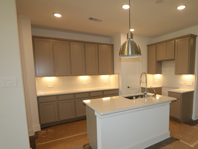 kitchen with recessed lighting, visible vents, a sink, and tasteful backsplash
