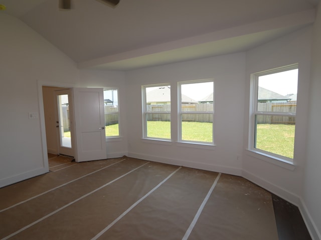 unfurnished room featuring a ceiling fan, baseboards, and vaulted ceiling
