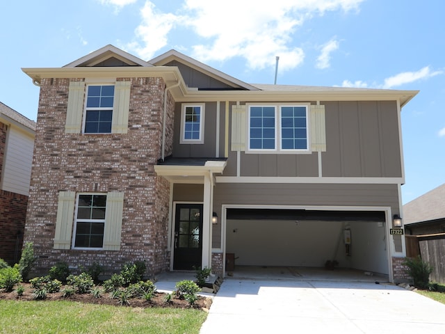 view of front of home with board and batten siding, brick siding, concrete driveway, and a garage