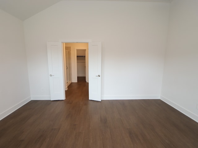 17322 Silver Birch Ct, New Caney, TX 77357 - empty room featuring dark wood finished floors, baseboards, and high vaulted ceiling