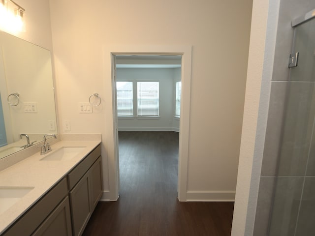 17322 Silver Birch Ct, New Caney, TX 77357 - full bathroom with wood finished floors, double vanity, baseboards, and a shower with shower door