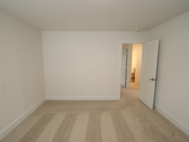 17322 Silver Birch Ct, New Caney, TX 77357 - empty room with light colored carpet, baseboards, and a smoke detector