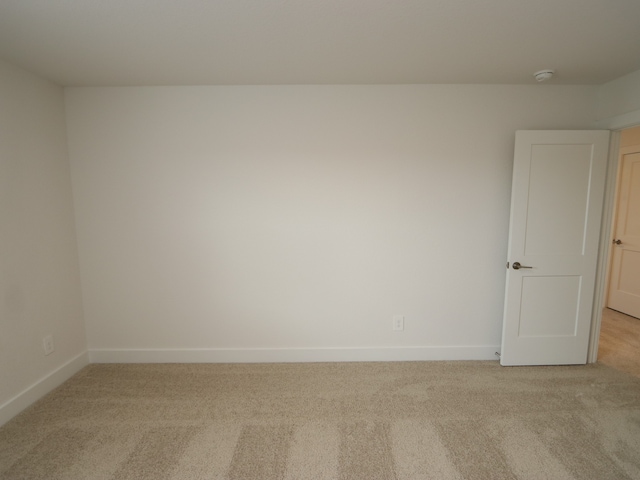 17322 Silver Birch Ct, New Caney, TX 77357 - unfurnished room with light carpet, baseboards, and a smoke detector