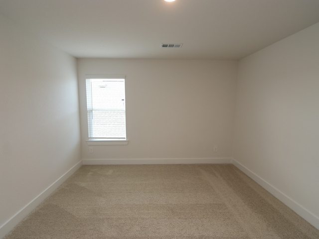 17322 Silver Birch Ct, New Caney, TX 77357 - spare room featuring baseboards and light colored carpet