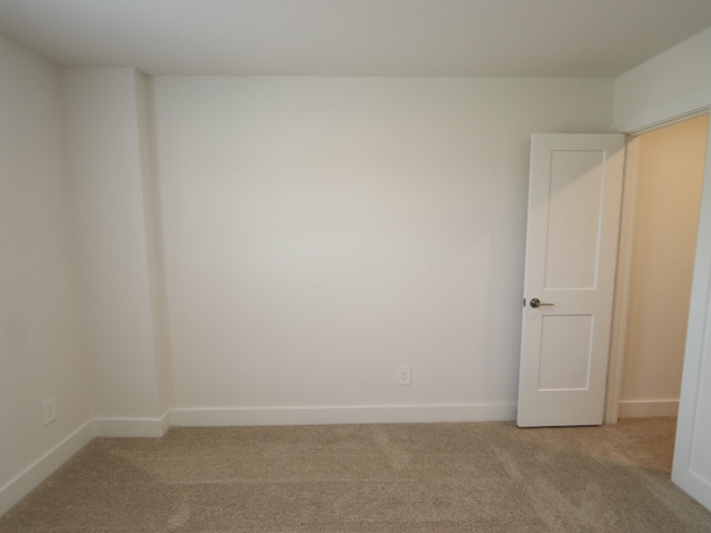 17322 Silver Birch Ct, New Caney, TX 77357 - unfurnished room featuring light carpet and baseboards