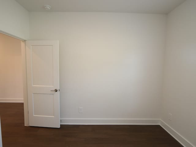 17322 Silver Birch Ct, New Caney, TX 77357 - unfurnished room featuring baseboards, dark wood finished floors, and a smoke detector