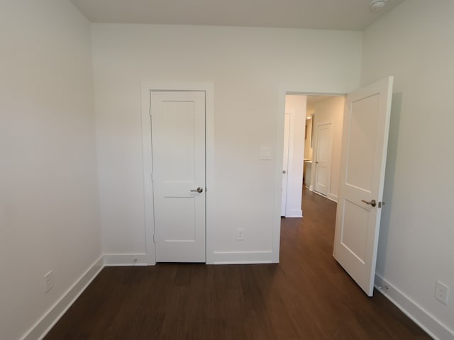 17322 Silver Birch Ct, New Caney, TX 77357 - unfurnished bedroom featuring dark wood-style flooring and baseboards