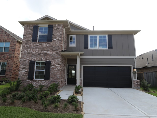 17322 Silver Birch Ct, New Caney, TX 77357 - view of front of property with an attached garage, driveway, board and batten siding, and brick siding