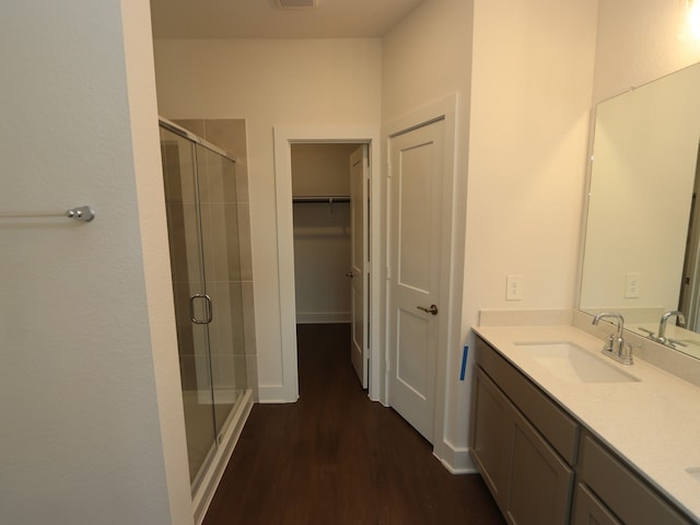 17322 Silver Birch Ct, New Caney, TX 77357 - bathroom featuring a shower stall, double vanity, wood finished floors, and a spacious closet