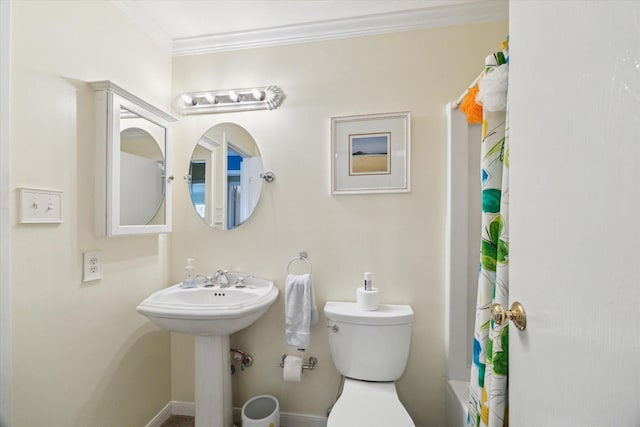 bathroom featuring sink, crown molding, and toilet