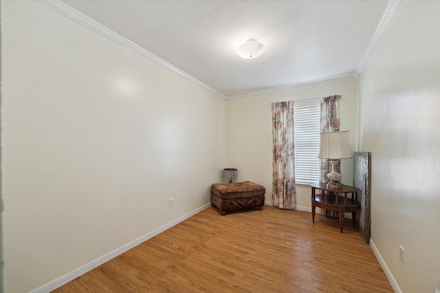 unfurnished room with ornamental molding and light wood-type flooring