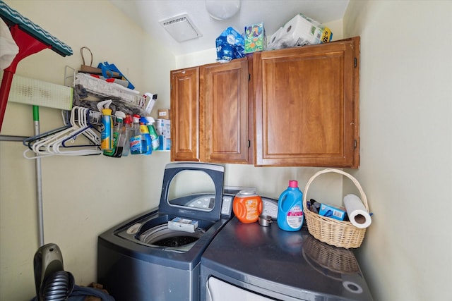 washroom featuring cabinets and washer and dryer