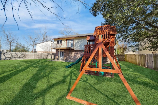 rear view of property with a playground and a yard