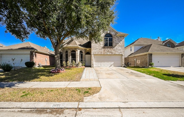 view of front of house featuring a garage and a front yard