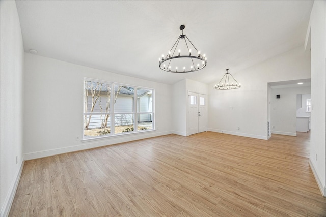 unfurnished living room featuring lofted ceiling, a notable chandelier, and light hardwood / wood-style flooring