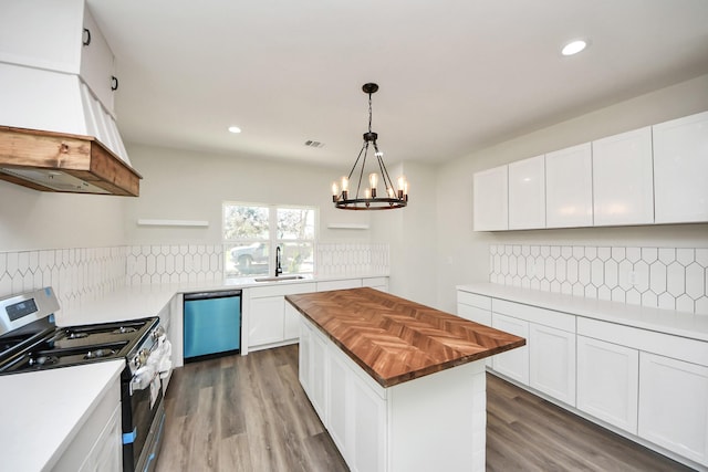 kitchen with stainless steel range with gas cooktop, a center island, and white cabinets