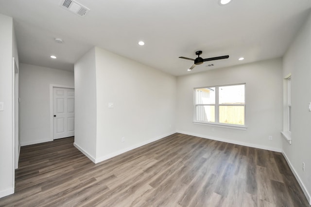 spare room featuring dark hardwood / wood-style floors and ceiling fan