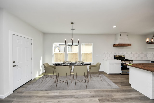 dining space featuring an inviting chandelier and wood-type flooring