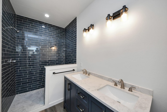 bathroom featuring vanity and tiled shower