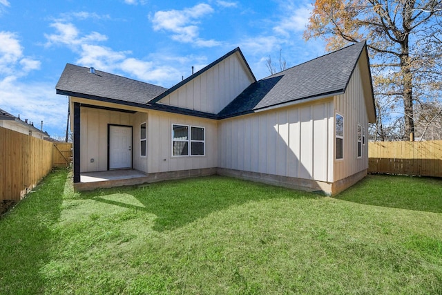 rear view of property with a yard