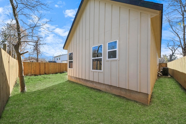 rear view of house with a yard and cooling unit