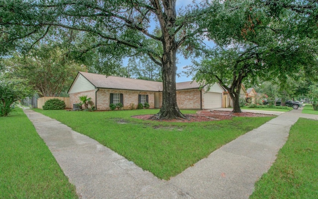 single story home with a garage and a front yard