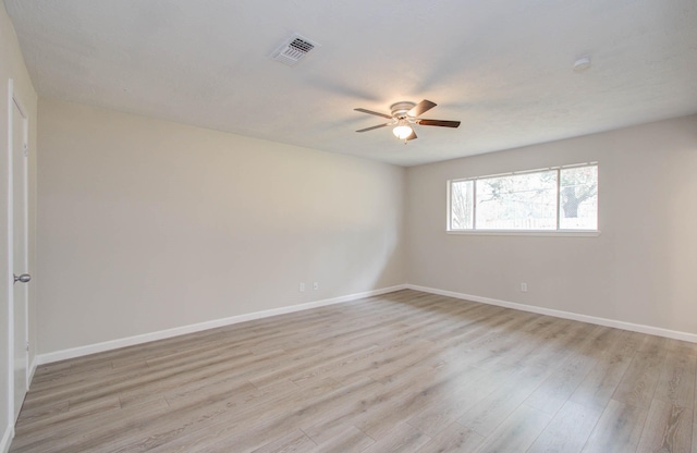 spare room featuring light hardwood / wood-style floors and ceiling fan