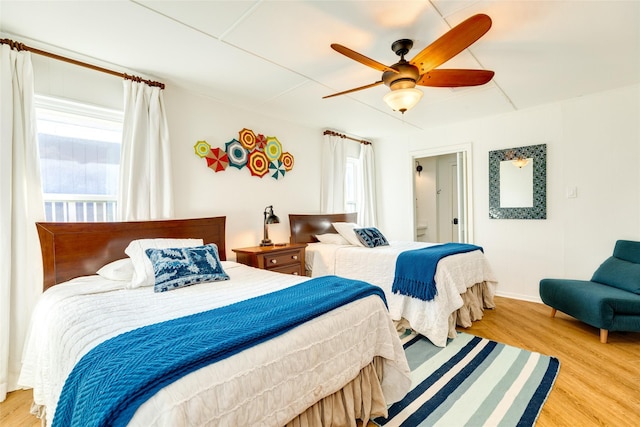 bedroom with light hardwood / wood-style floors and ceiling fan