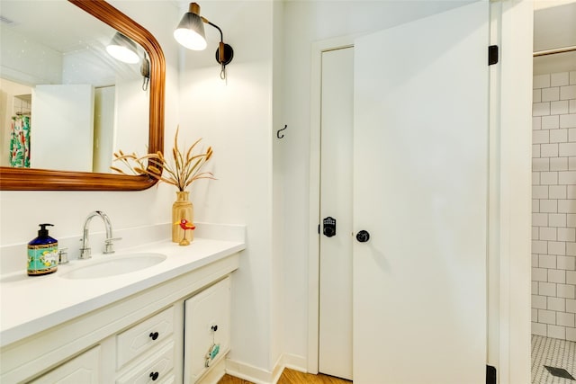 bathroom featuring vanity and tiled shower