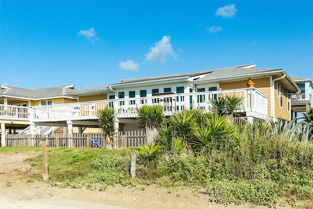 rear view of property featuring a wooden deck