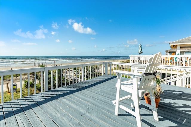 deck featuring a water view and a beach view