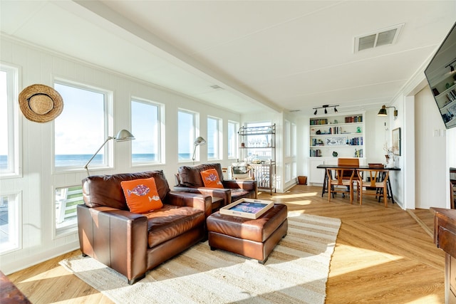 sunroom / solarium with plenty of natural light and rail lighting