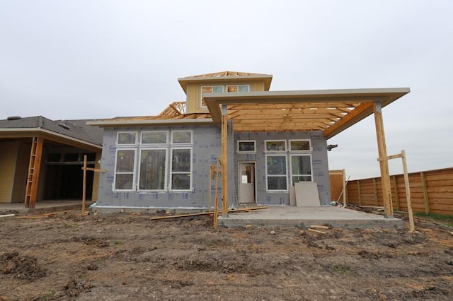 rear view of property with a patio area and fence