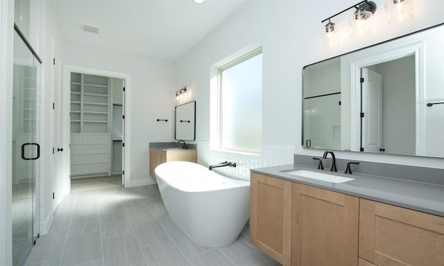 bathroom featuring plus walk in shower and vanity