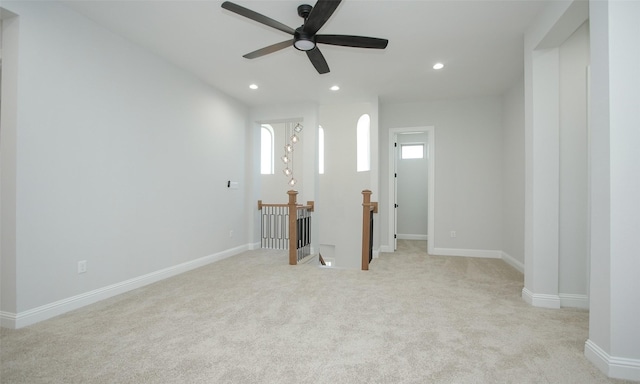 interior space with ceiling fan and light colored carpet