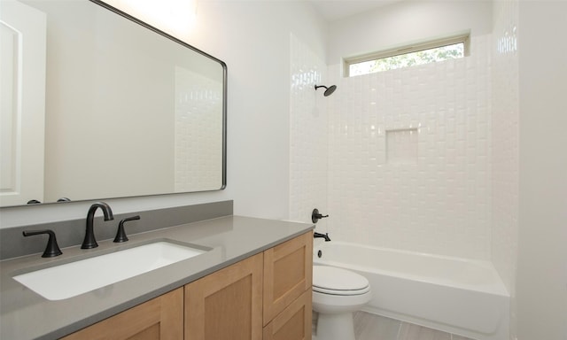 full bathroom with vanity, toilet, and tiled shower / bath combo