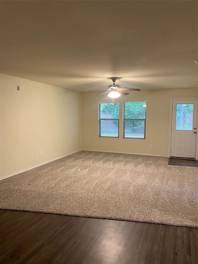 empty room with ceiling fan, hardwood / wood-style flooring, and a healthy amount of sunlight