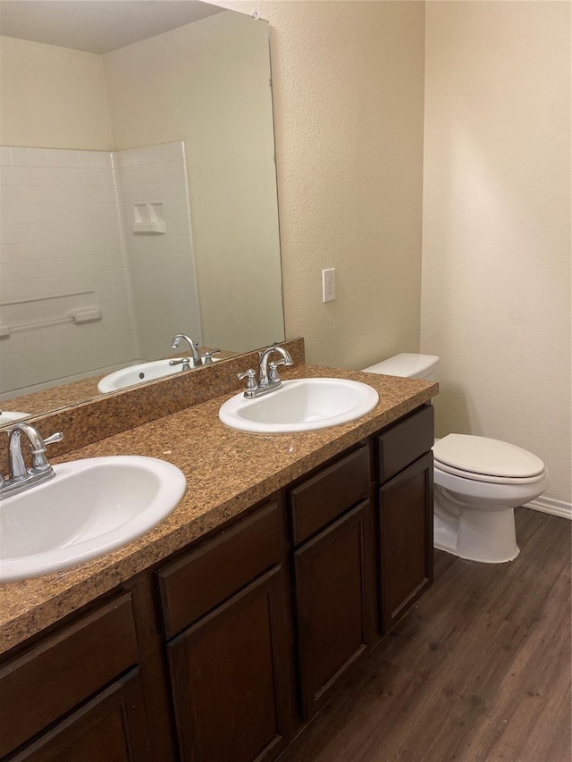 bathroom featuring wood-type flooring, vanity, and toilet